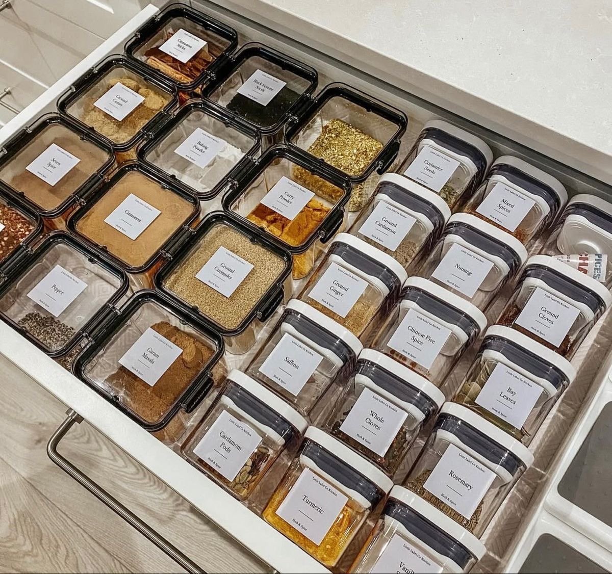 Organised drawer with labelled spice jars