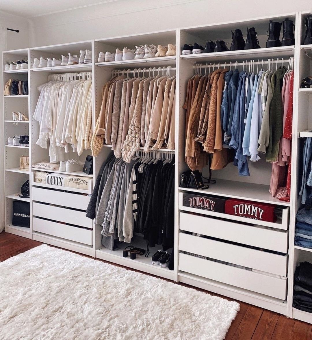 Organised walk-in closet with hanging clothes